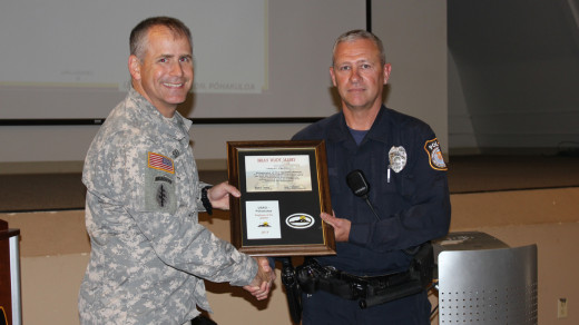  Lt. Col. Eric Shwedo, PTA commander (left) shakes hands with Department of the Army police officer Brian Mabry, photo courtesy  U.S. Army Garrison-Hawaii Public Affairs Office