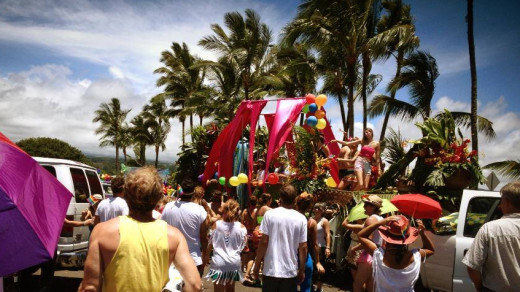A dance party breaks out surrounding a parade float in Hilo