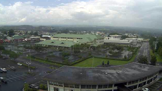 The UH-Hilo webcam stationed at the Hilo Lagoon center shows the government buildings downtown after a soaking, taken 12:16 p.m. HST