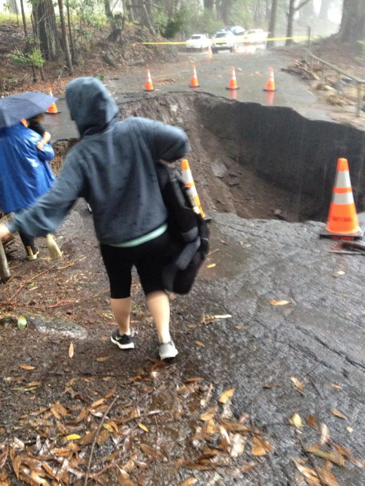 Residents of Paauilo mauka, stranded by the closed road, make their way to the highway makai in order to make their escape. Photo by Liana Iaea Honda