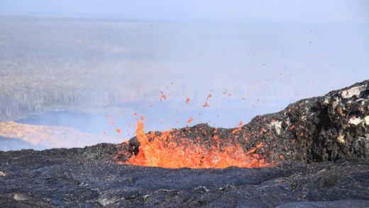 USGS HVO photo: The lava pond at the northeast cone had several spatter sources active on the pond margin, throwing spatter to a height of a few meters (yards).