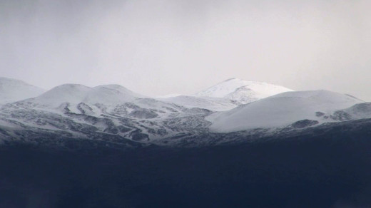 Mauna Kea snow as seen from below in Waimea. This image was captured by Lynn Beittel of Visionary Video during a momentary break in the clouds.