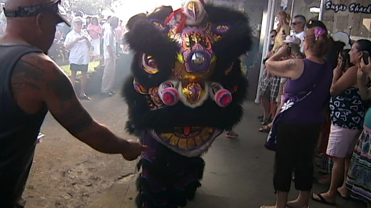 Lion Dancers entertain a swarm of visitors downtown