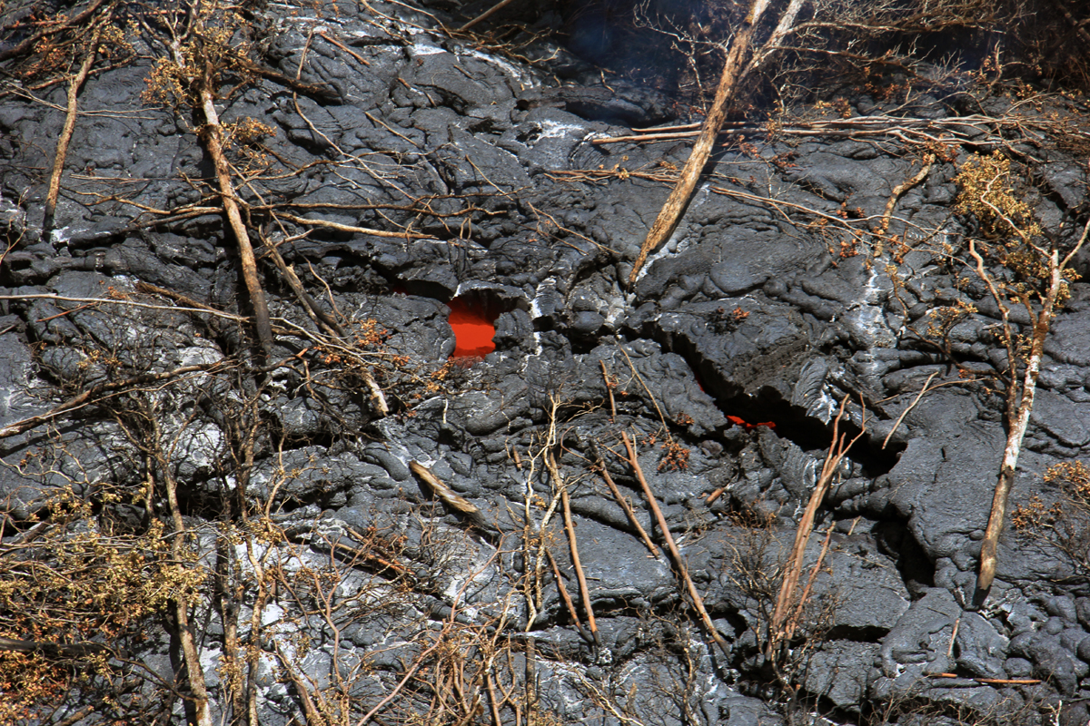 The isolated pad of lava that emerged from the deep ground crack several days ago did not have any active breakouts at the surface today, but incandescent lava could be seen in numerous cracks on the surface. This likely represents lava that had ponded within the flow and remains hot, but immobile. (USGS HVO)