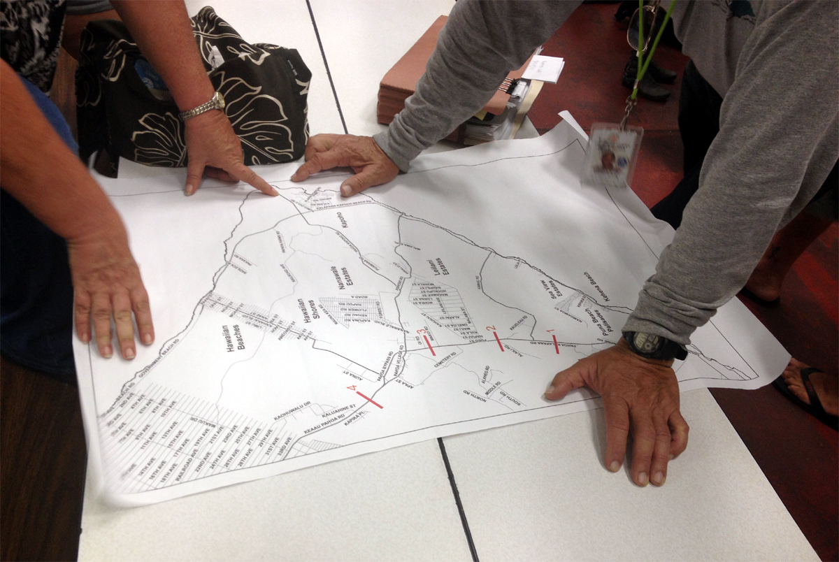 Once the meeting ended, residents joined officials in the study of maps, discussing possible evacuation routes for the future.