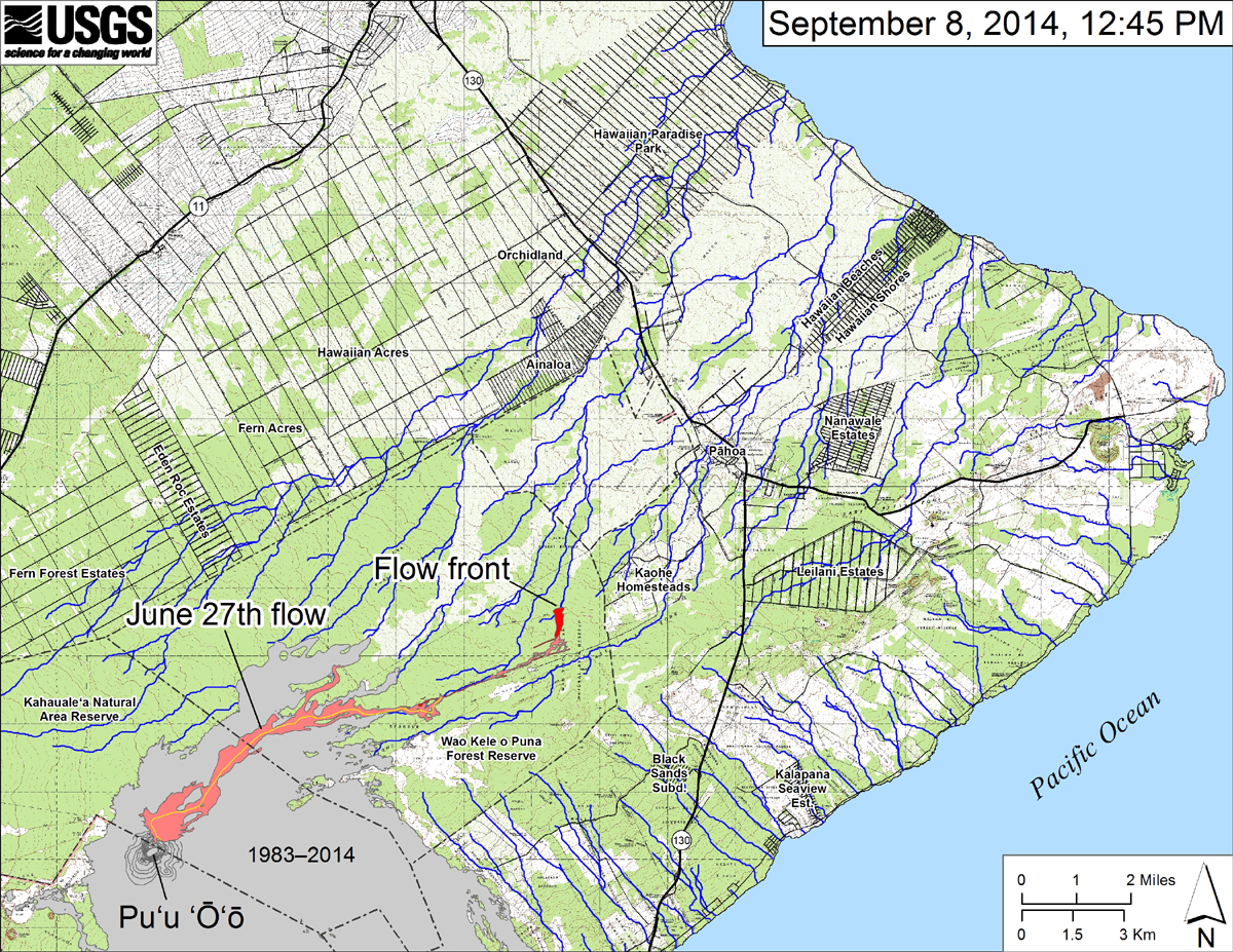 (USGS HVO) This small-scale map shows the June 27th flow in Kīlauea’s East Rift Zone as of September 8, 2014. The area of the flow on September 6 is shown in pink, while widening and advancement of the flow as mapped on September 8 at ~12:45 PM is shown in red. The front of the active flow was 13.7 km (8.5 miles; straight-line distance) from the vent and 1.2 km (0.7 miles) from the east boundary of the Wao Kele o Puna Forest Reserve. The flow was advancing toward the north, roughly parallel to the Forest Reserve boundary. The blue lines show down-slope paths calculated from a 1983 digital elevation model (DEM). For an explanation of down-slope path calculations, see: http://pubs.usgs.gov/of/2007/1264/. All older Puʻu ʻŌʻō lava flows (1983–2014) are shown in gray; the yellow line marks the lava tube. 