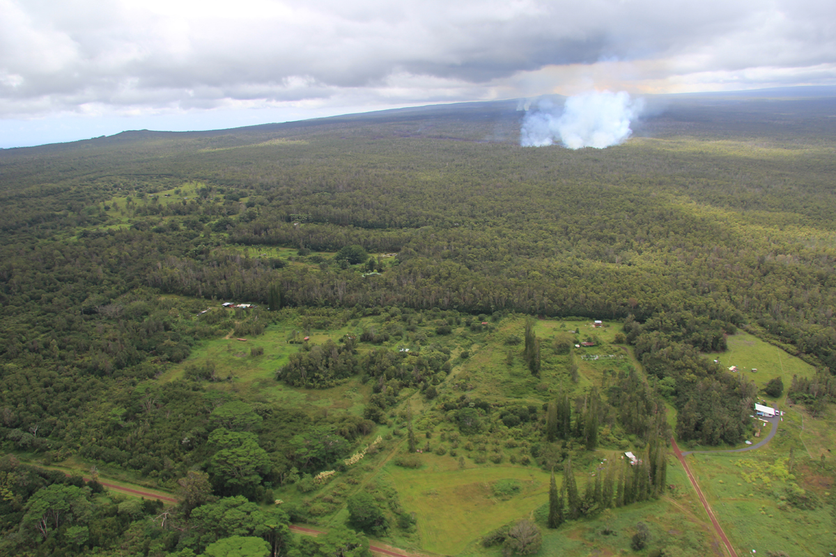 (USGS HVO on Sept. 8) The June 27th flow continues its advance toward the north, creating a dense smoke plume as it spreads through the forest. The tip of the active flow today was 13.7 km (8.5 miles) straight-line distance from the vent, and 1.2 km (0.7 miles) from the eastern boundary of the Wao Kele o Puna Forest Reserve. This boundary is the western edge of Kaohe Homesteads subdivision, seen in the foreground. Puʻu ʻŌʻō is visible on the horizon, partly obscured by the smoke plume. The actual length of the flow, measured along its axis, is 15.7 km (9.8 miles).