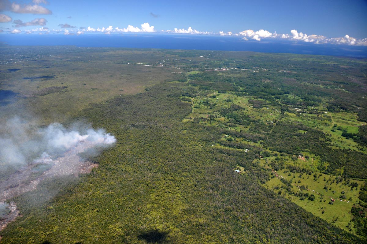 USGS HVO: "View looking northeast along the terminus of the July 27th flow. Kaohe Homesteads is to the right, and Pāhoa town is in the middle center. The active flow is in the middle left."