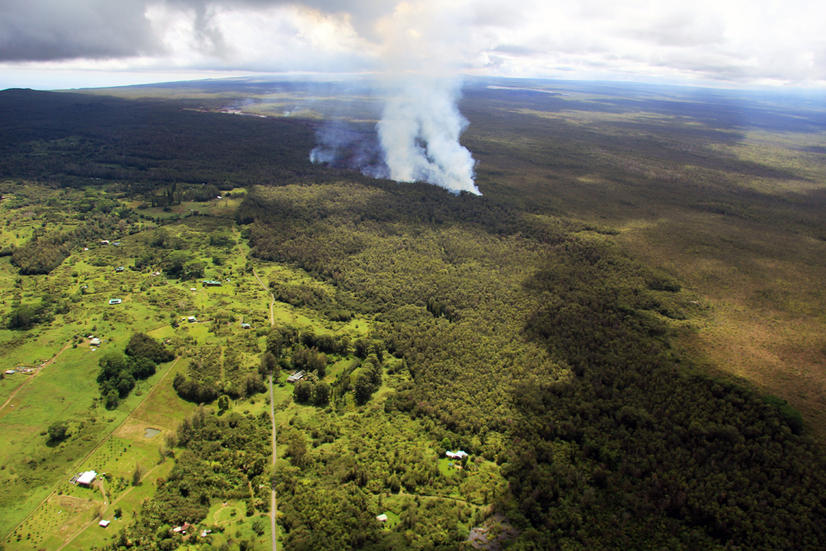 Wide shot of the flow front taken by USGS HVO, showing the lava moving through the forested northwest portion of the Kaohe subdivision. The flow front was 3.3 km (2.1 miles) upslope from Apaʻa Road and 4.3 km (2.7 miles) from Pāhoa Village Road.