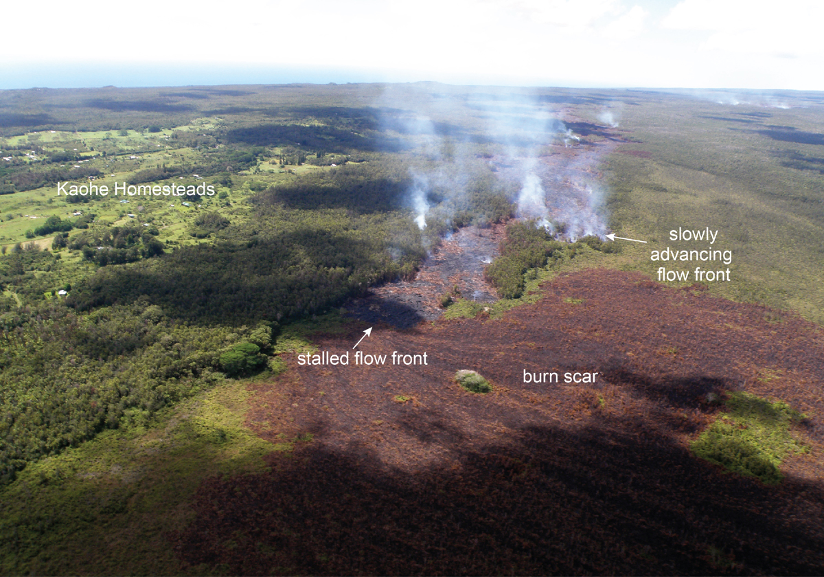 USGS posted this photo on September 24, saying, "The leading edge of the June 27th flow stalled over the weekend, but active breakouts persist near the flow front, a short distance behind this stalled front. Today, lava was slowly advancing on a different front, along the north margin of the flow. The burn scar from a brush fire triggered by the lava this weekend covers much of the lower portion of the photograph."