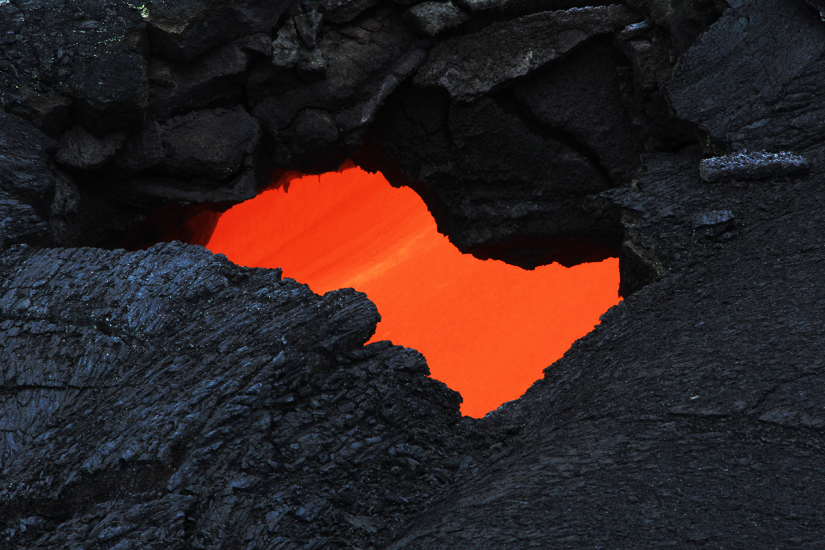 USGS HVO photo shows a skylight which provided a view of the swiftly moving lava stream in the lava tube.