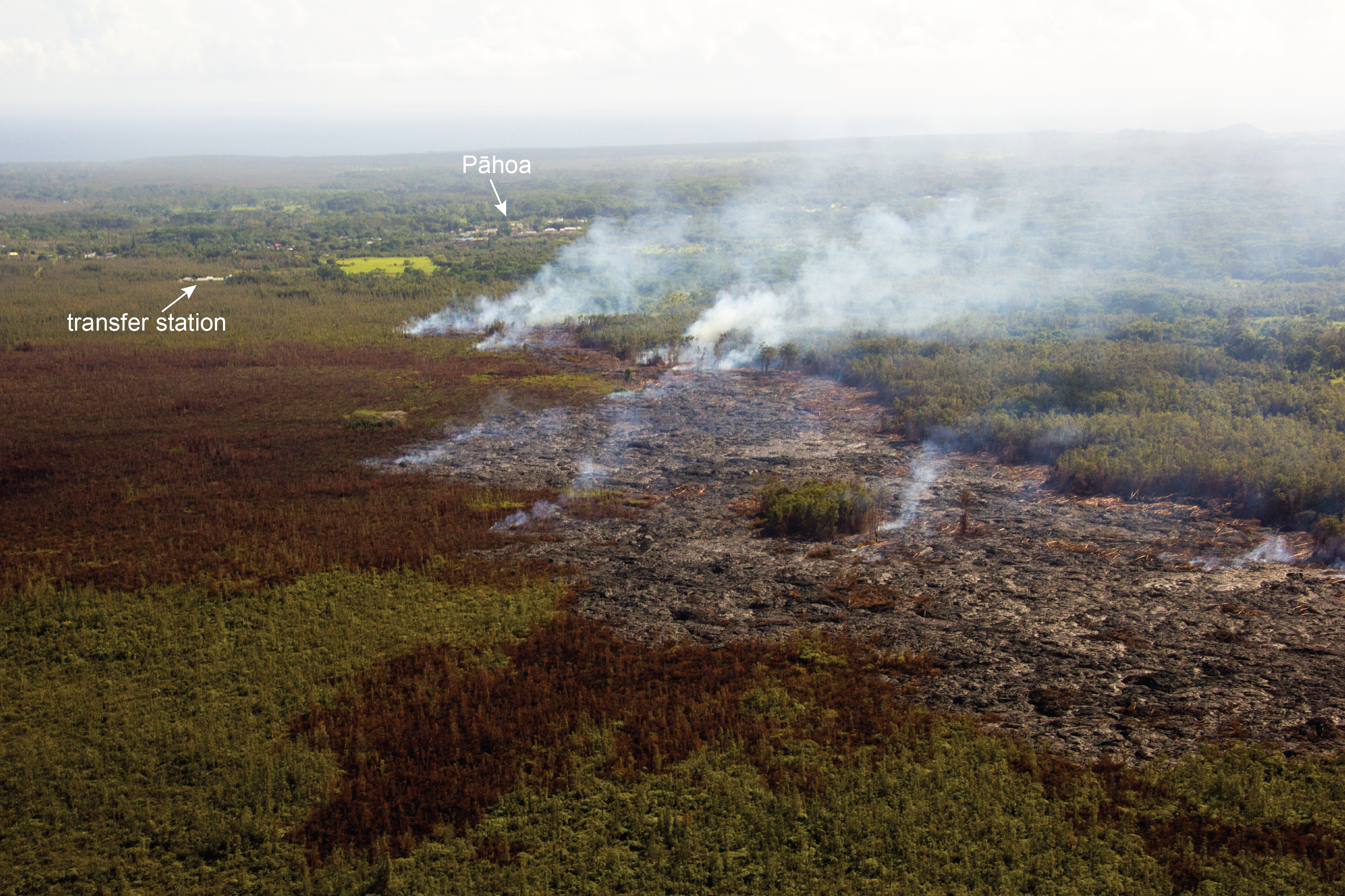 This USGS photo, looking down flow and taken at a low altitude, shows the flow front direction relative to the transfer station and Pāhoa.