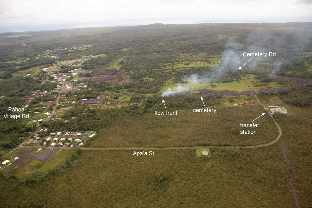 This annotated USGS photograph shows the notable features around the flow front. The photo was taken at 11:30 am on Monday, and also shows the distance the flow front has traveled between Cemetery Rd./Apaʻa St. and Pāhoa Village Rd.