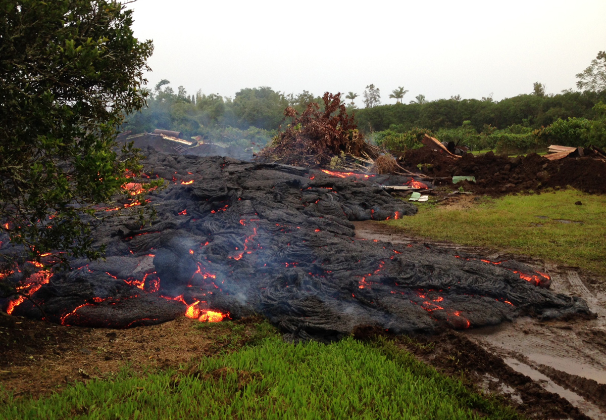 This USGS Hawaiian Volcano Observatory photo from 6:30 a.m., HST, on Wednesday, October 29, 2014, shows lava from the June 27th flow continuing to move downslope through the property it entered the previous morning. 