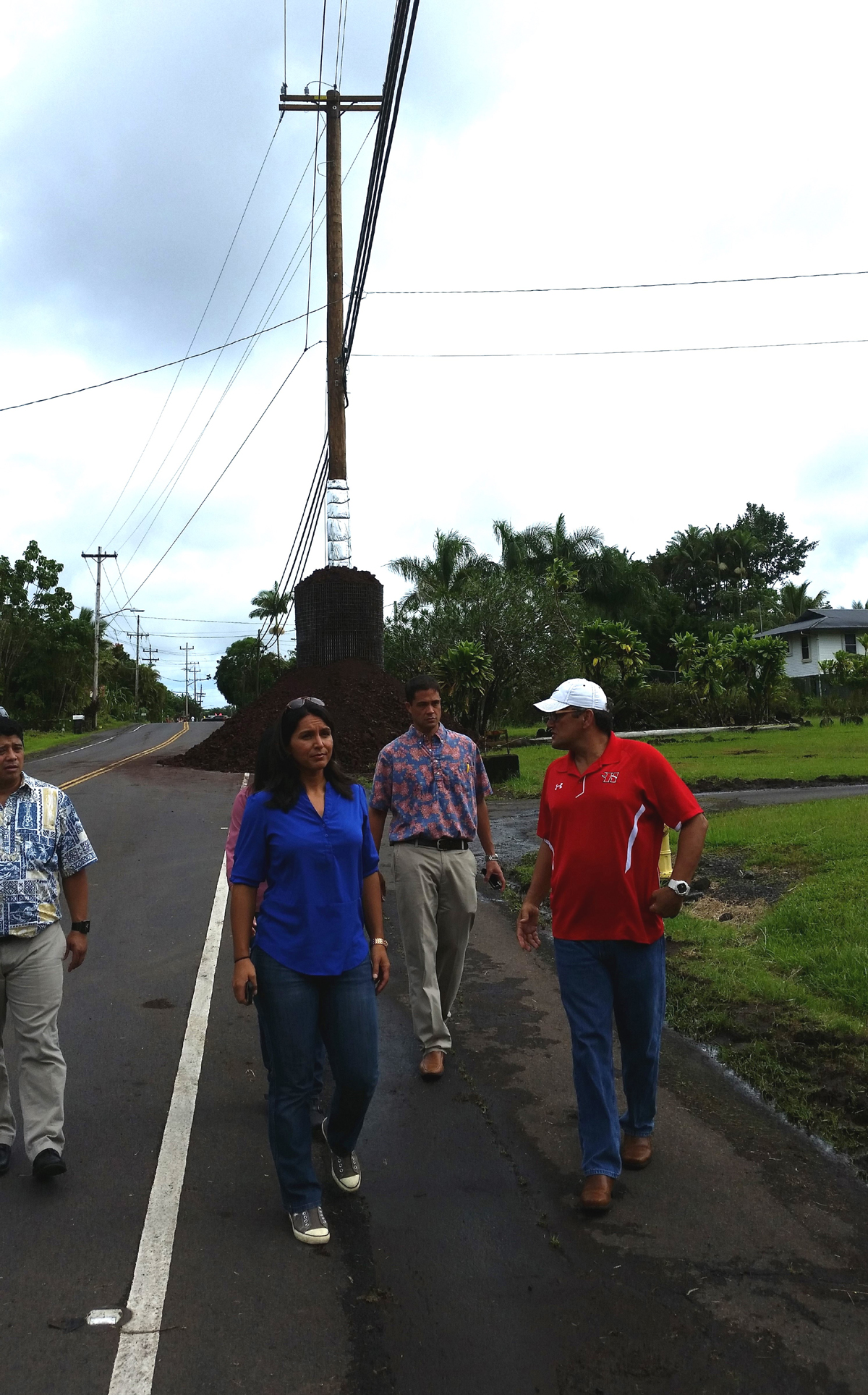 Rep. Tulsi Gabbard tours the area where the lava is expected to cross Pahoa Village Road, where retrofitted utility poles await the flow. Photo courtesy Office of Congresswoman Tulsi Gabbard.