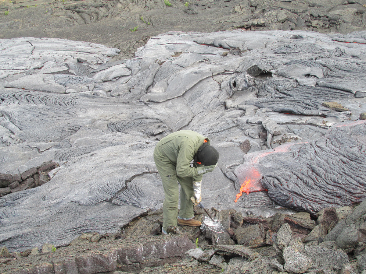 A geologist is seen taking a sample of molten lava in this USHS HVO photo from Nov. 17. The geologist will quench it in a bucket of cold water to "freeze" the crystalline structure. Lava samples are collected once a week to track the chemistry of the erupted lava over time." width="1200" height="800" class="size-full wp-image-16080" /> A geologist is seen taking a sample of molten lava in this USHS HVO photo from Nov. 17. The geologist will quench it in a bucket of cold water to "freeze" the crystalline structure. Lava samples are collected once a week to track the chemistry of the erupted lava over time.