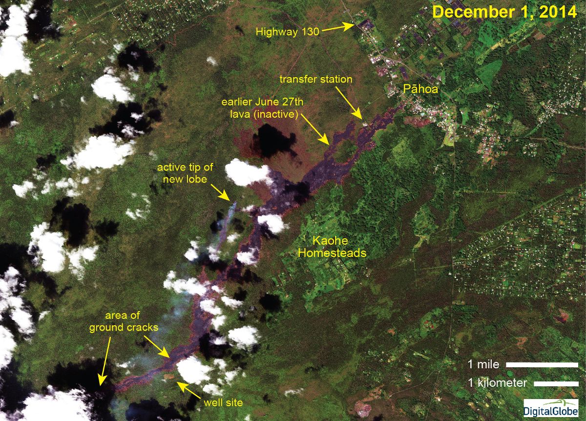 This USGS Hawaiian Volcano Observatory image was acquired yesterday (December 1, 2014) by the WorldView 2 satellite, and shows the activity in the downslope portion of the June 27th lava flow. The portion of the June 27th lava flow that entered Pāhoa in October is inactive, but a new lobe is advancing downslope a short distance west of the earlier flow. The leading tip of the new lobe is evident by its long smoke plume, caused by vegetation burning. A Civil Defense overflight this morning (December 2, 2014) showed that this active tip continues to move towards the northeast.