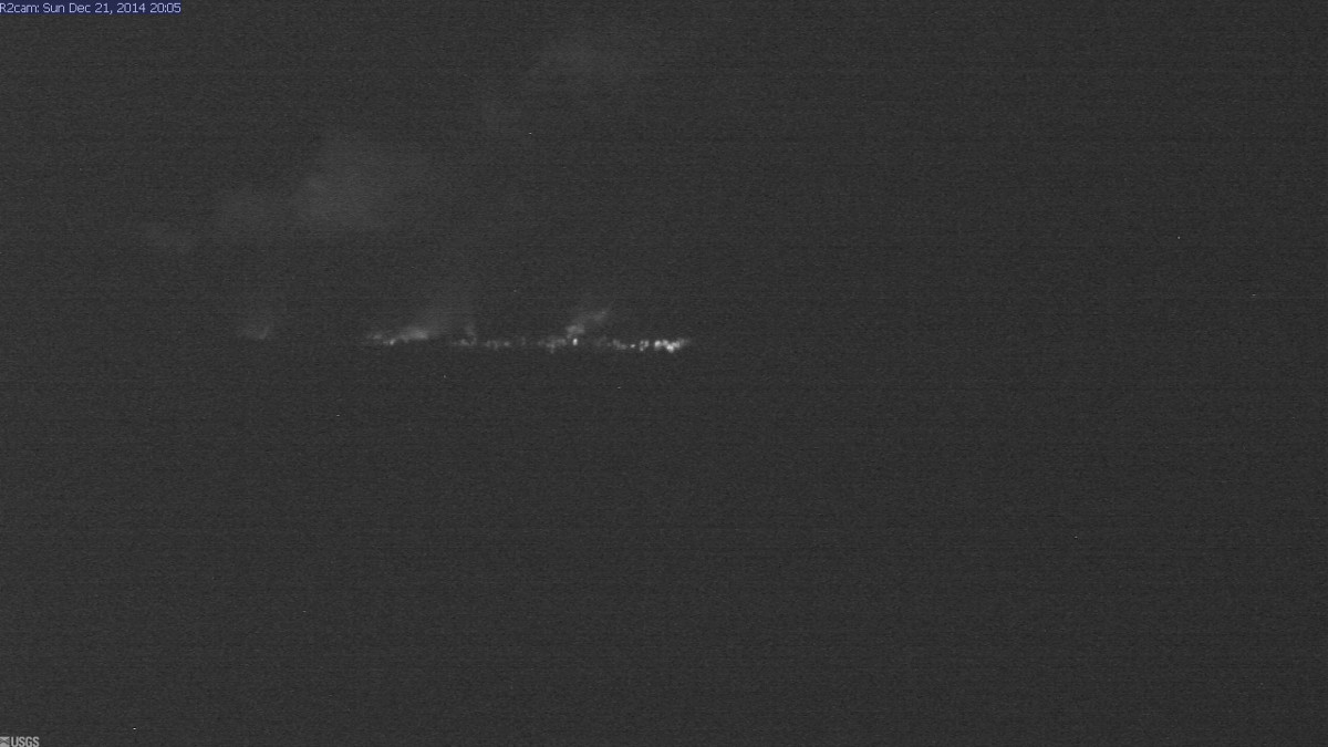 Tonight's view (Dec. 21) looking west from a USGS research webcam temporarily positioned southeast of the Pāhoa Marketplace. The glow from the June 27th lava flow, advancing from left to right, appears to be diminished compared to webcam views on previous nights.