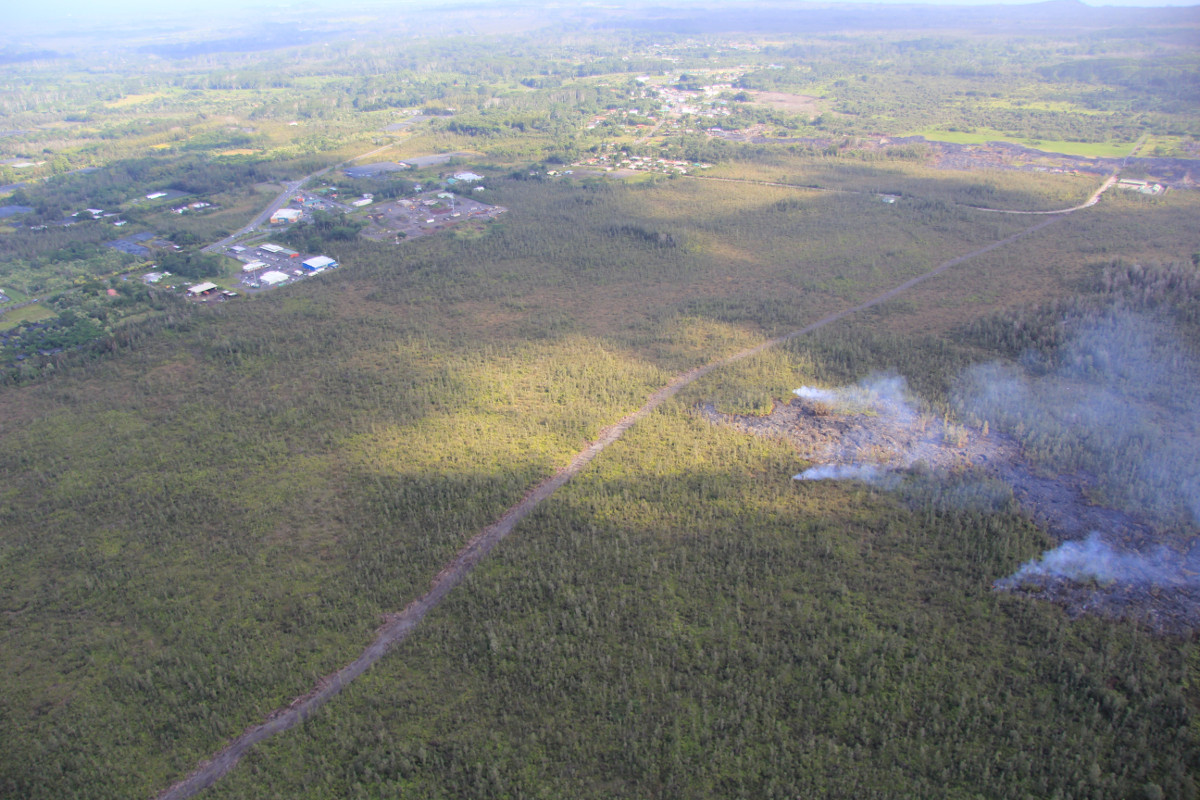 This USGS photo shows the flow was very close to a firebreak road cut several months ago. The Pahoa Transfer Station is at upper right. The view is to the southeast.