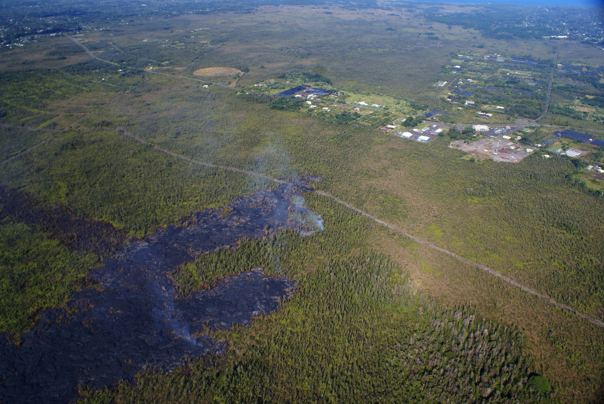 USGS photo: The leading part of the flow consisted of several small, active lobes Tuesday afternoon. The front of the lobe that crossed the firebreak was stalled, though breakouts were active about 50 m (55 yd) upslope. Another lobe (area of most visible smoke in center) was about 300 m (330 yd) upslope of the tip and 150 m (165 yd) upslope of the firebreak. A third lobe was 350 m (385 yd) upslope of the firebreak. The view is to the northeast.