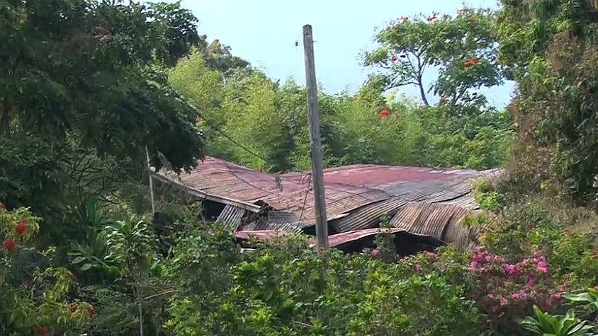 The partially collapsed roof of the burned home was visible from the highway on Thursday. Image courtesy Visionary Video.