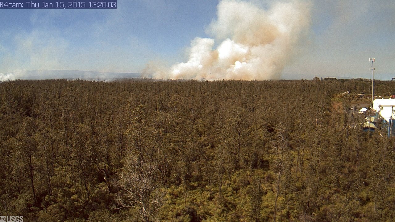 USGS webcam image taken at 1:20 p.m. HST looking upslope from the Pahoa Market Place at the brush fire. 