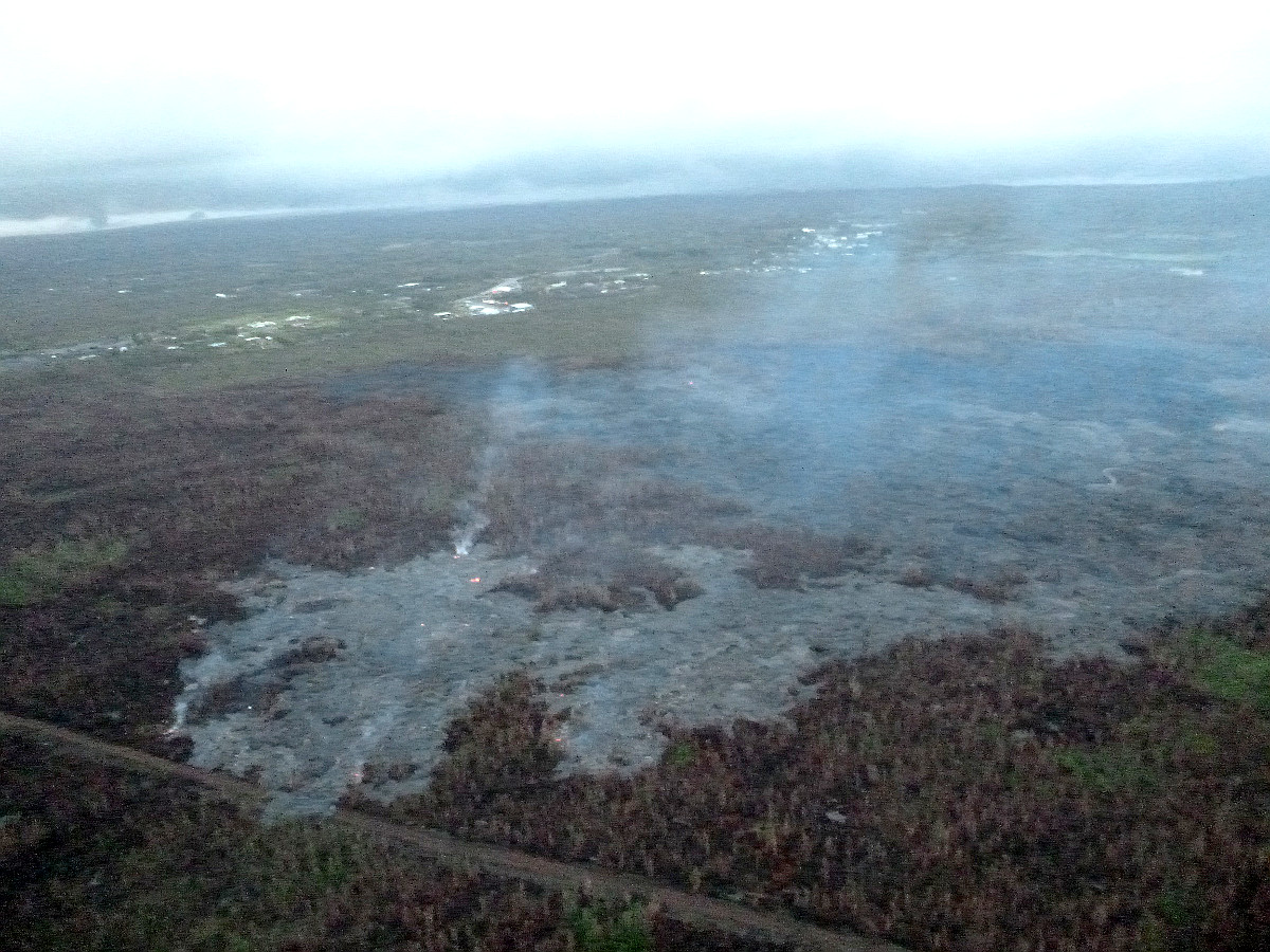 Civil Defense image from this morning’s overflight shows the breakout along north margin, looking down slope towards Highway 130. The lava crossed the fire break road.