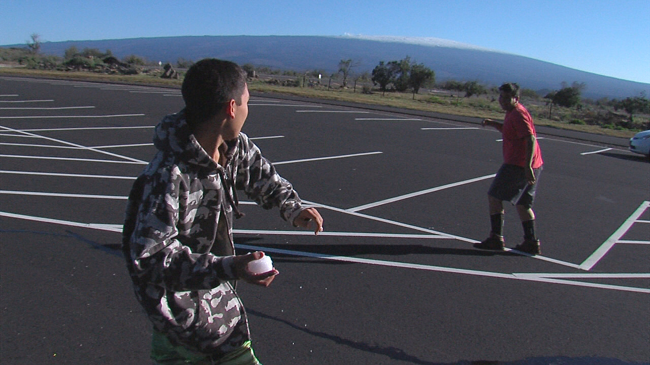 Snowballs fly below the summit at Mauna Kea Recreation Area along Saddle Road. Snow capped Mauna Loa is in the distance.