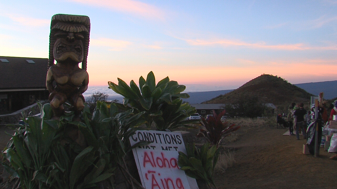 Kū, present on the day of the arrests and since, seen in the foreground as the sun rises over Hawaii Island on Thursday morning.