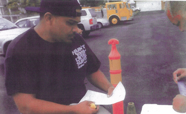 DLNR photo - part of the BLNR submittal - shows officers serving  Orion Enocencio with a cease and desist order on July 23, 2014.
