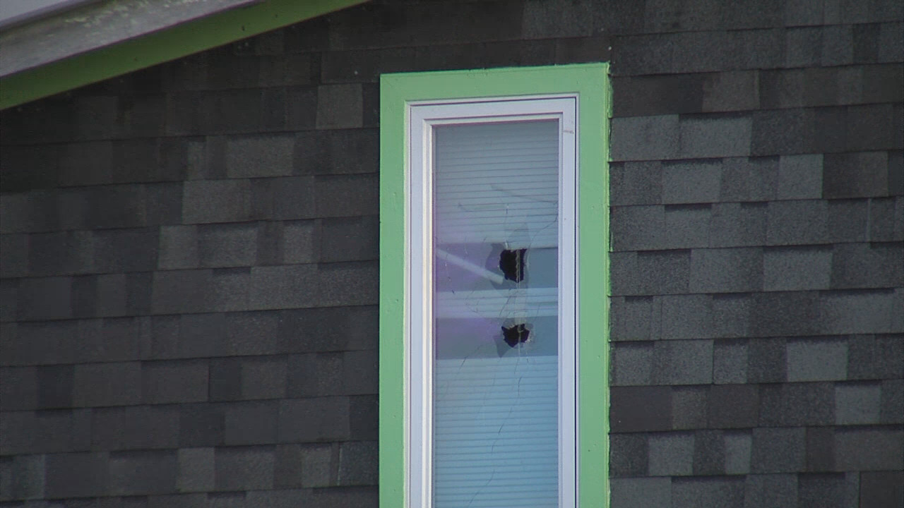 Holes were shot  through the window of the home where a 20 hour standoff concluded on Tuesday with the arrest of the suspect barricaded inside.