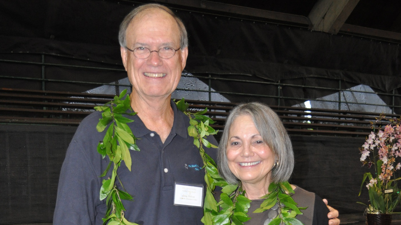 Andy Wilson & Sandy Song in 2012. The Hilo Orchid Show Preview Party on Thursday, August 6 is dedicated to the late Sandra Song (right) as a tribute to her years of devoted board service to Ku‘ikahi Mediation Center, and her avid orchid growing and judging.  The late Song and Judge Andrew Wilson (left) were founding board members of Ku‘ikahi.