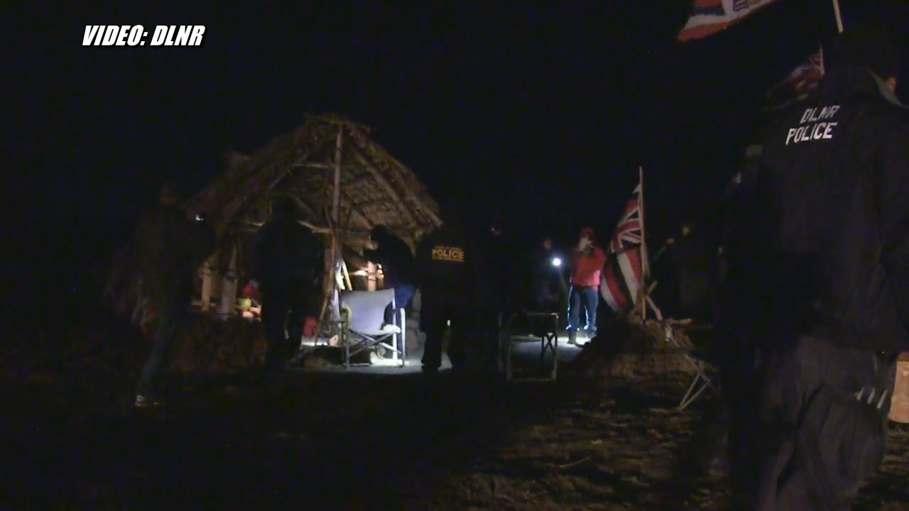 Arrestees were apparently huddled together in Hale Kukiaimauna when they were taken by DLNR officers. Image from DLNR video.