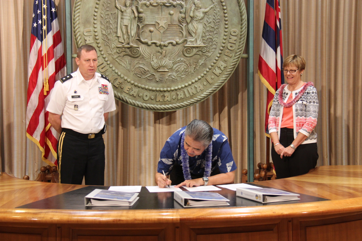 Gov. David Ige, Karen Armes, Acting Regional Administrator for FEMA Region IX, and Major General Arthur J. Logan, Director of Emergency Management, sign the 2015 Hawaii Catastrophic Hurricane Plan (photo courtesy Office of the Governor).