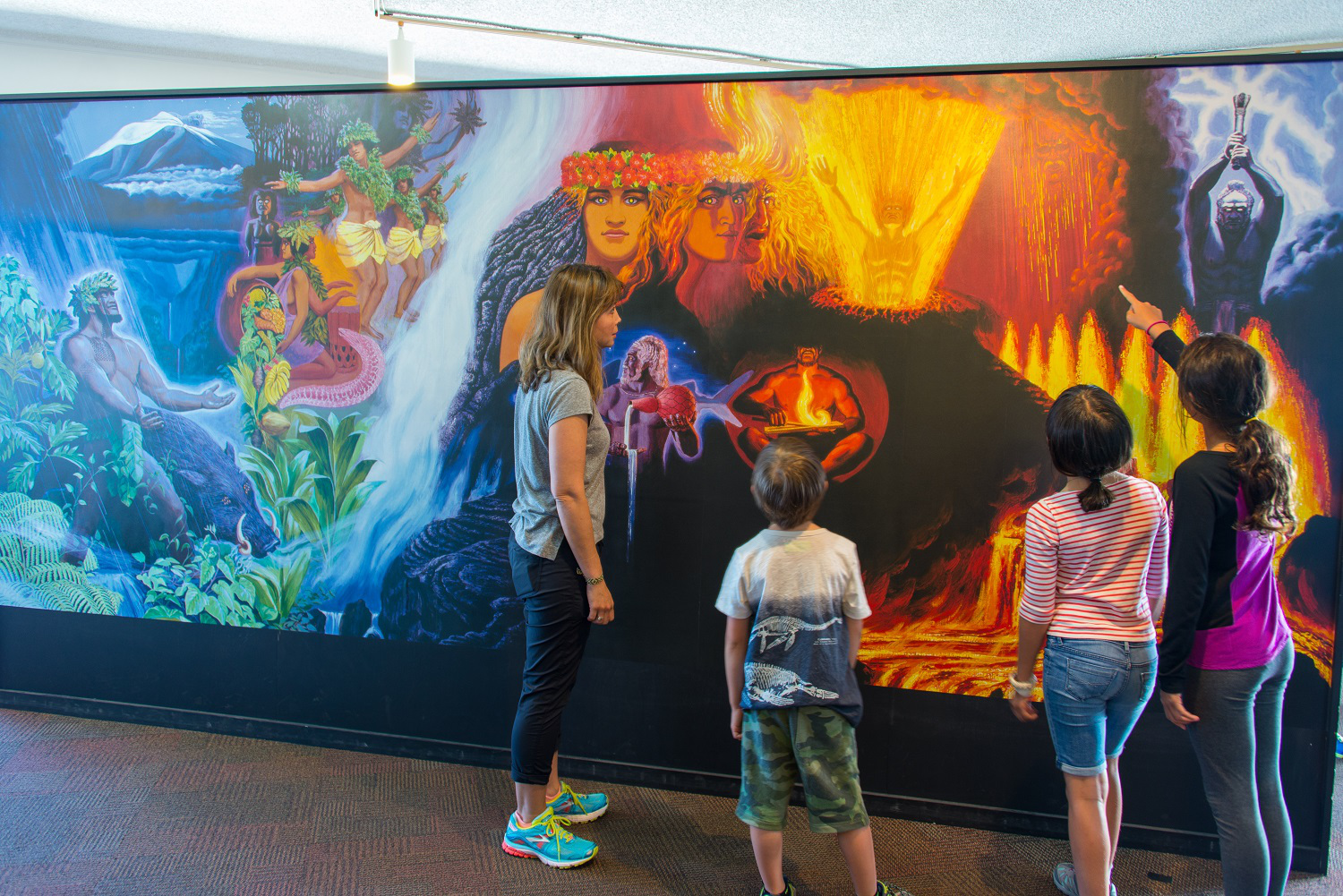 (NPS Photo/Stephen Geiger) Visitors admire the newly restored Herb Kane mural, A Pantheon of Volcano Spirits, in Hawai‘i Volcanoes National Park's Jaggar Museum. 