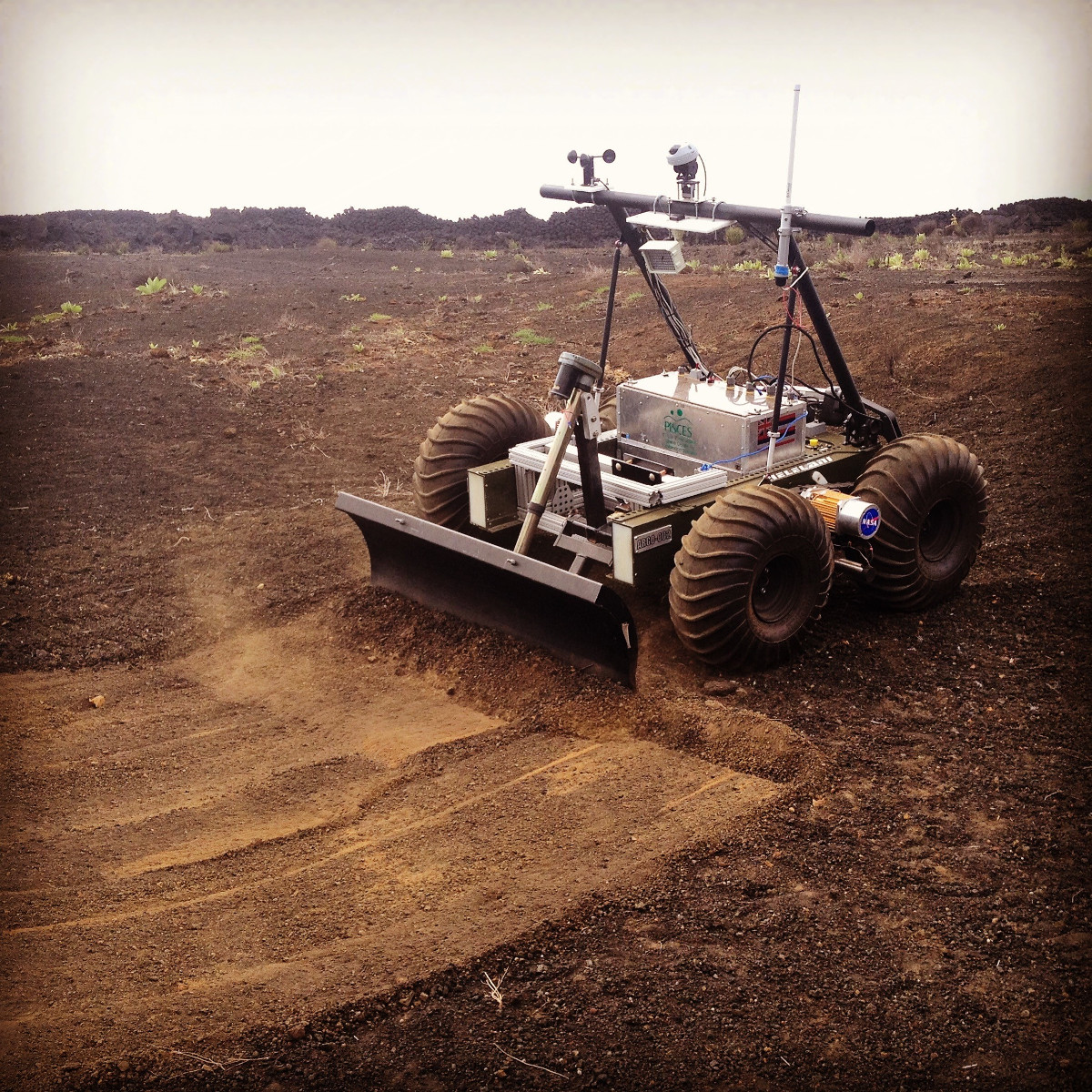 (photo: PISCES) The Helelani Rover during initial integration tests with one of the end effectors to be used in the site preparation phase of the lunar landing pad project.