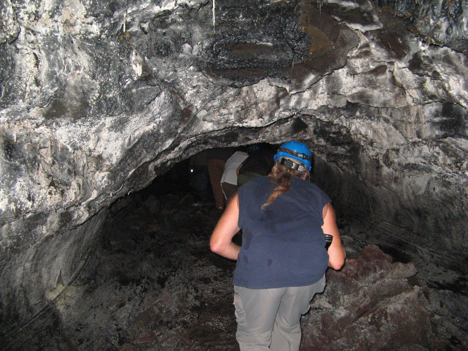 Crouching for the low ceiling in Puapo‘o lava tube (NPS Photo/Stephen Geiger) ​