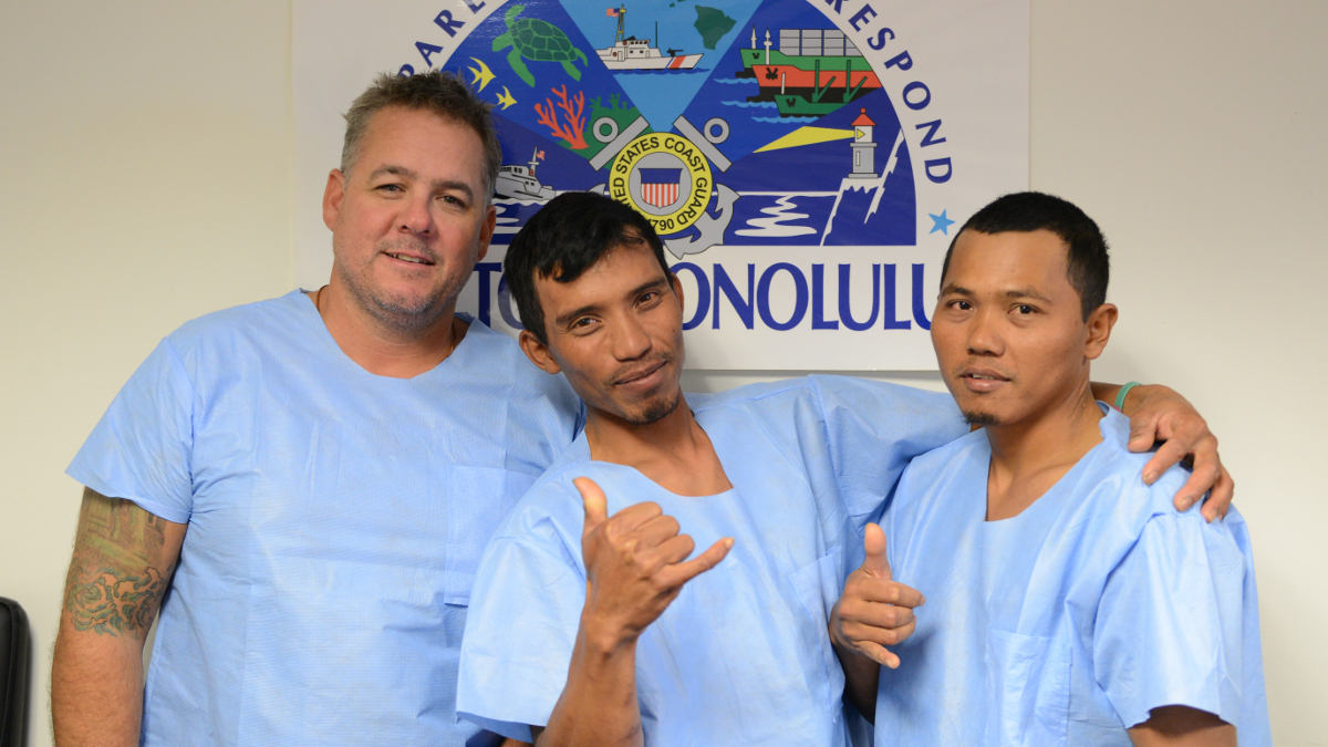 Jonathan Hoag, the captain of the fishing vessel Vicious Cycle, and his two crew members, Zaenal and Syamsul, are all smiles after being rescued by the Navy and Coast Guard, after their vessel sank 161 miles southwest of Kona, Hawai'i, March 11, 2016. The survivors were located and rescued fairly quickly due to having a properly registered emergency positioning indicating radio beacon and the proper emergency and survival equipment. (U.S. Coast Guard photo by Petty Officer 2nd Class Tara Molle/Released)
