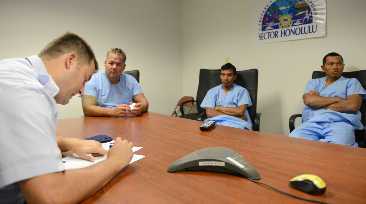 Petty Officer 1st Class Dustin Welch, an operations specialist at the Coast Guard 14th District, conducts a post search and rescue debrief with the survivors of the fishing vessel, Vicious Cycle, at Pier 4, March 11, 2016. The survivors were located and rescued fairly quickly due to having a properly registered emergency positioning indicating radio beacon and the proper emergency and survival equipment. (U.S. Coast Guard photo by Petty Officer 2nd Class Tara Molle/Released)