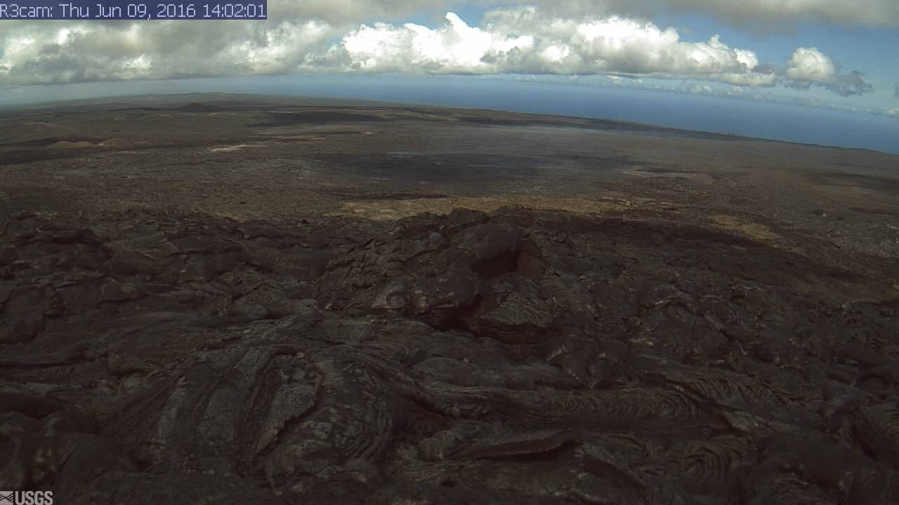 This USGS image is from a research camera positioned on the southeast flank of Puʻu ʻŌʻō, looking toward the active flow advancing to the southeast. The breakout point is at the left edge of the image, and the mid-field skyline at the right is roughly coincident with the top of the pali. See it live here.