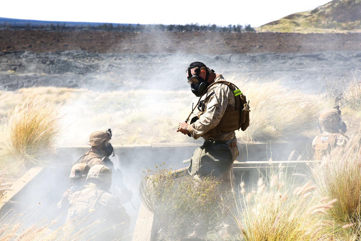 A Marine with Kilo Company, 3rd Battalion, 3rd Marine Regiment, observes as Marines are gassed in trenches during training exercise Lava Viper, a staple of their pre-deployment training, at Range 10 aboard Pohakuloa Training Area, Hawaii, Nov. 4, 2015. (U.S. Marine Corps photo by Lance Cpl. Harley Thomas)
