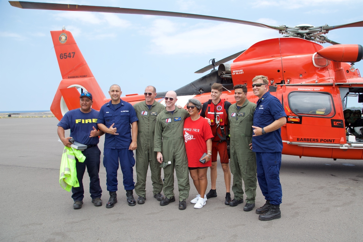 Coast Guard and Hawaii Fire Department personnel stand with the mother of Sidney Uemoto following her daughter's rescue. (U.S. Coast Guard photo/Released)