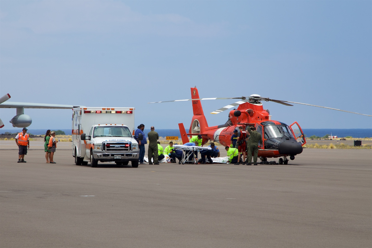 Coast Guard crews safely deliver David McMahon and Sidney Uemoto to emergency medical personnel in Kona, Hawaii, July 15, 2016. (U.S. Coast Guard photo by Lt. Cmdr. Kevin Cooper/Released)