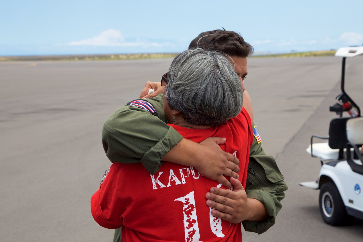 The mother of Sidney Uemoto hugs Coast Guard crews following her daughter's rescue.  (U.S. Coast Guard photo by Lt. Cmdr. Kevin Cooper/Released)