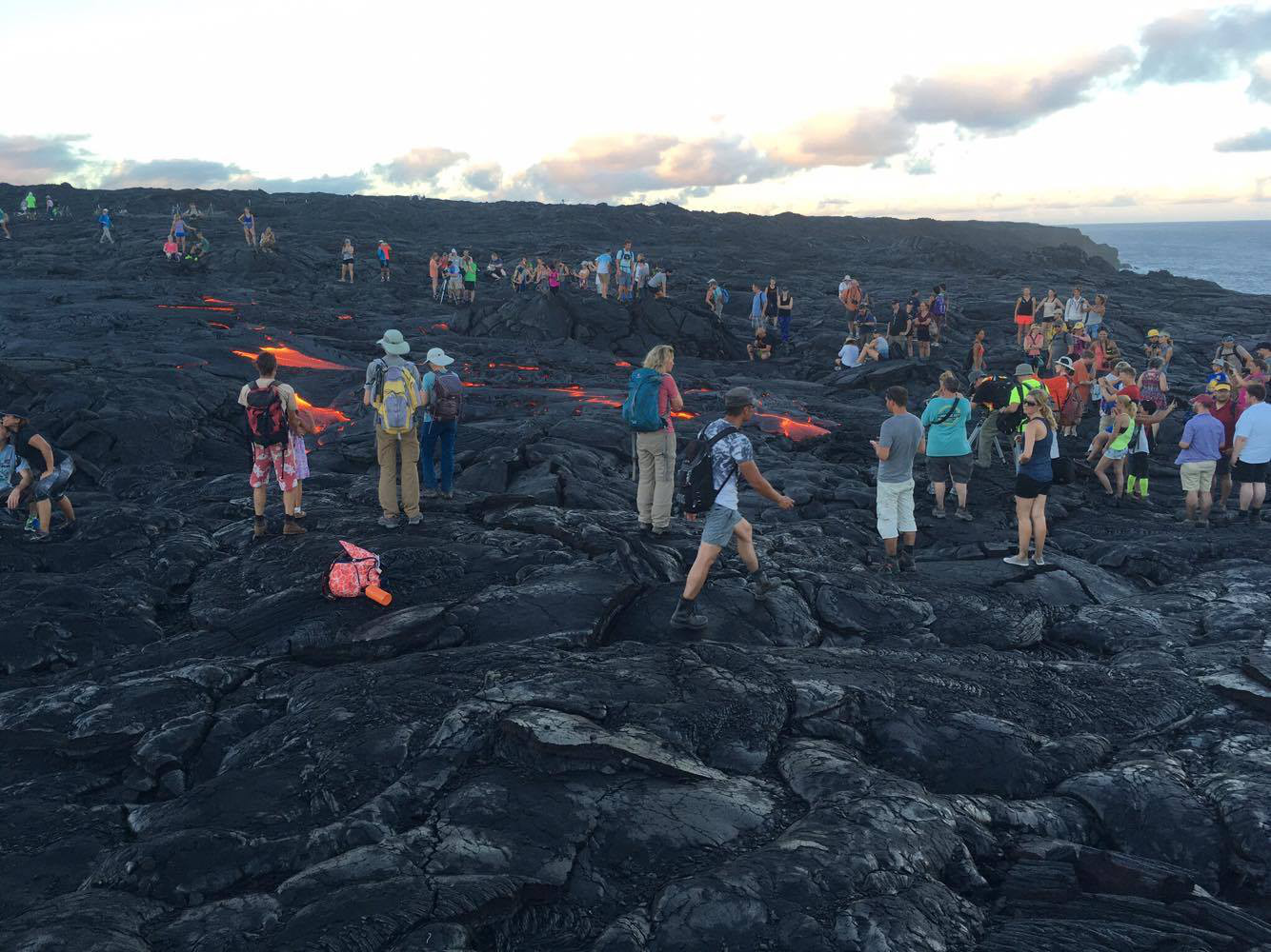 A crowd gathers around the distal tip of the 61g lava flow as it crosses the road en route to the ocean. Photo by John Tarson of Epic Lava.