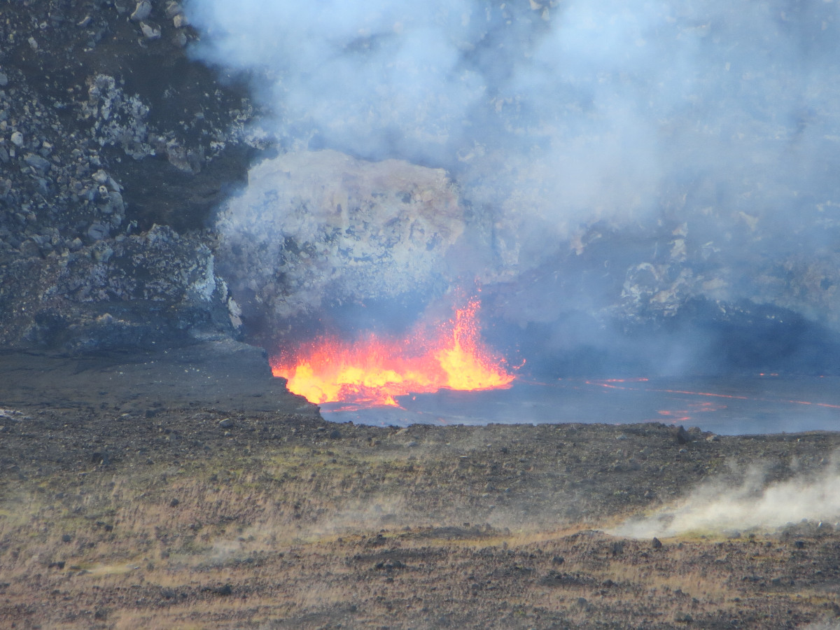 This telephoto image provides a closer view of the lava lake within Halemaʻumaʻu Crater and spattering on the lake surface. (USGS photo)