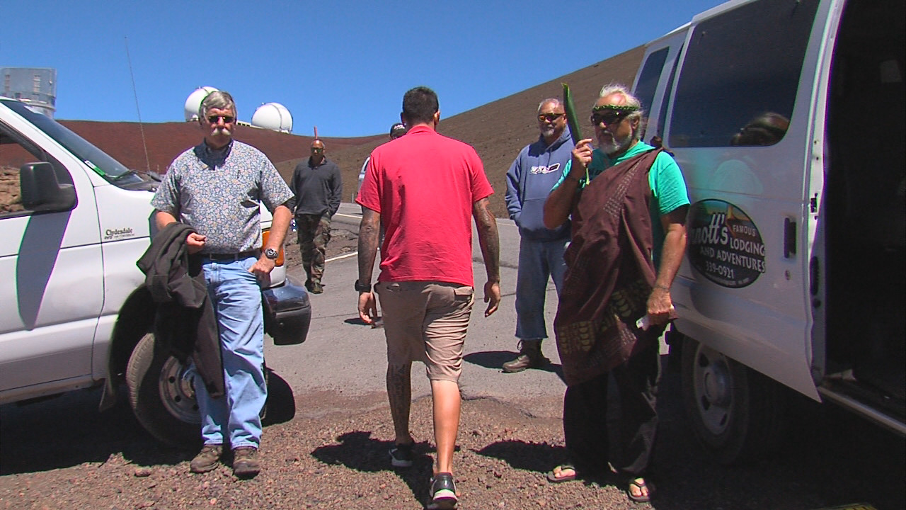 Participants get out of their cars, briefly, at the site of the planned batch plant near the summit of Mauna Kea.