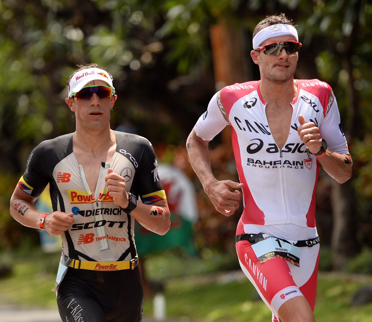 DOUBLE DEUTSCHE. German rivals Jan Frodeno #1 and Sebastian Kienle race shoulder-to-shoulder during the marathon portion of the 2016 IRONMAN World Championship triathlon on October 8, 2016 in Kailua Kona, Hawai'i. Frodeno and Kienle finished No. 1 and 2, respectively, followed by fellow countryman Patrick Lange, as Germany swept the podium for the first time in 19 years. (Photo by Donald Miralle/IRONMAN) –  Copyright © 2016 IRONMAN