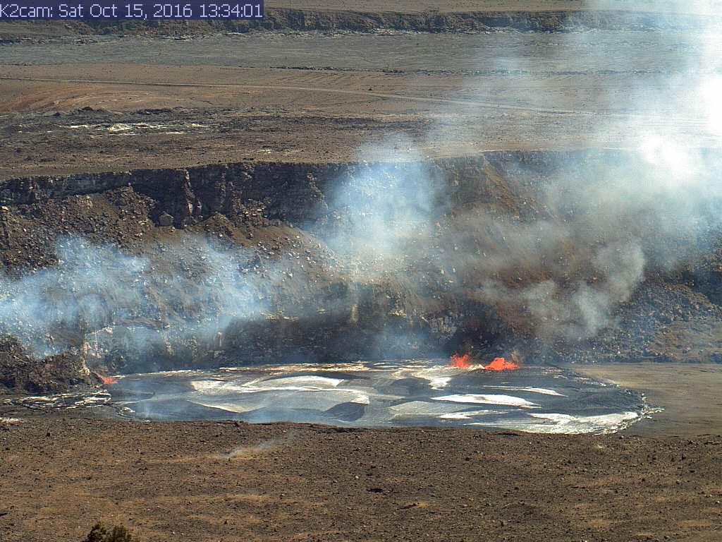 (USGS photo) In this image, captured by HVO's K2 webcam, you can see small spill-overs (shiny black lava) on the east (far left) and west (right) sides of the vent rim. 