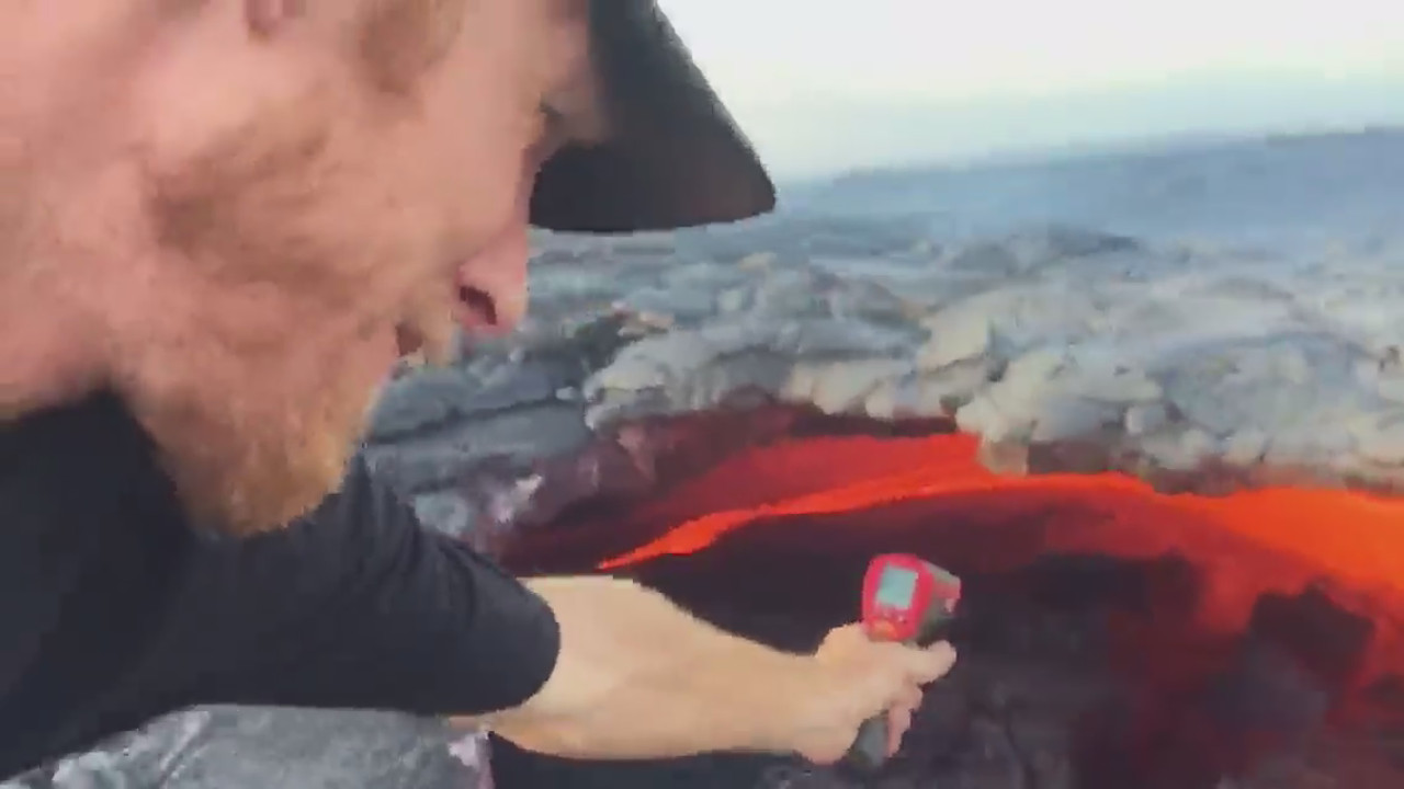 John Tarson takes the temperature near the skylight. (courtesy video by Epic Lava Tours)